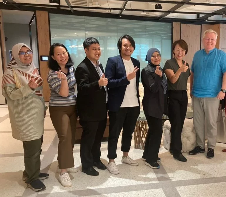 A group of people posing for a picture in an office.