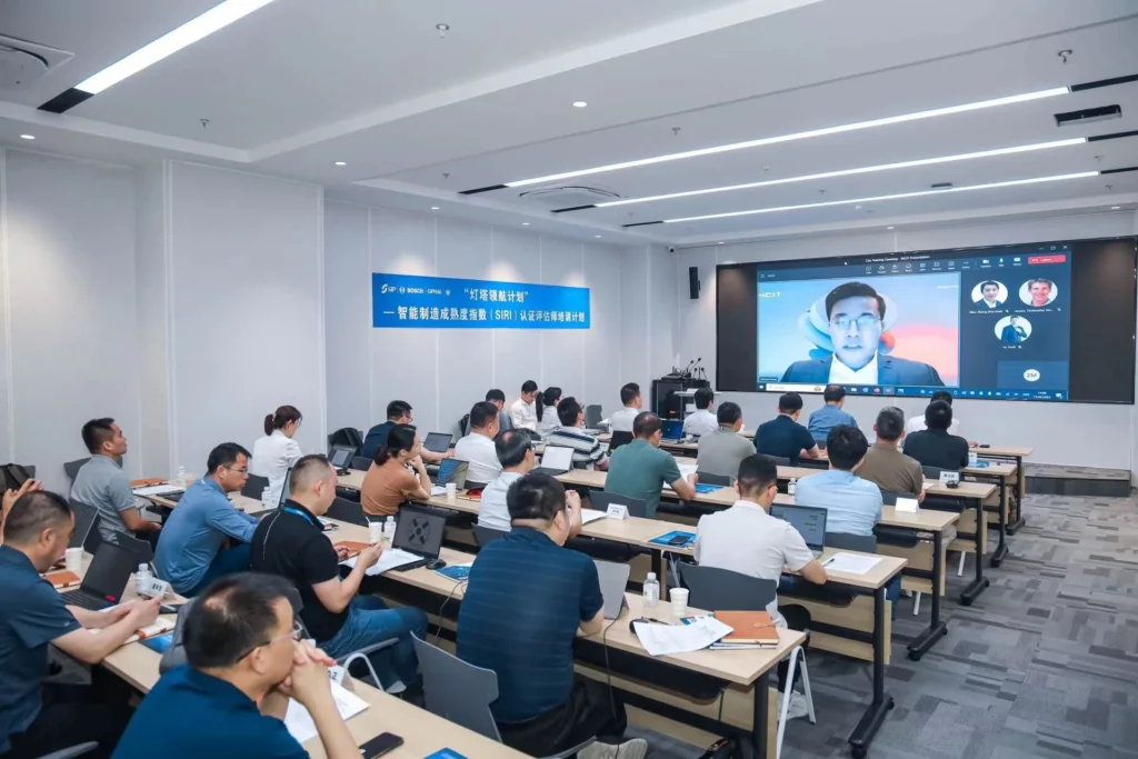 A group of people in a conference room watching a video.