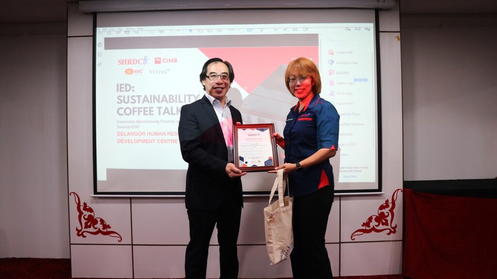 A man and woman holding a certificate.